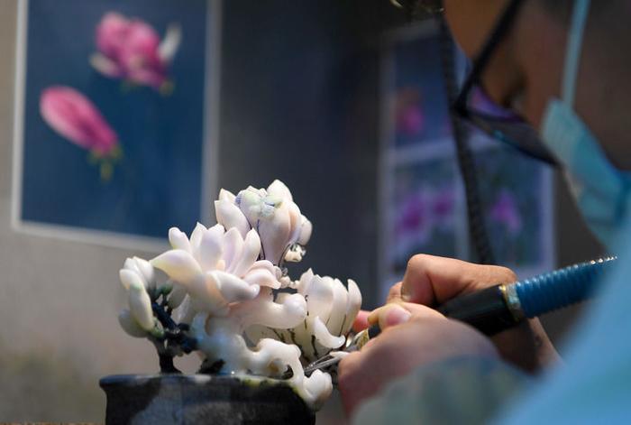 河南省南阳市镇平县玉雕大师创意园一家工作室内，一名玉雕工作者在雕刻玉器（3月12日摄）。新华社记者 郝源 摄